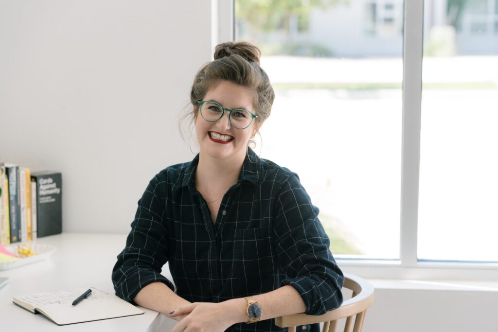 Lianna Patch at her desk, grinning